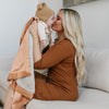 Soothing receiving blanket with a gentle, plush front and a satin back, providing a cozy and elegant wrap for your little one.