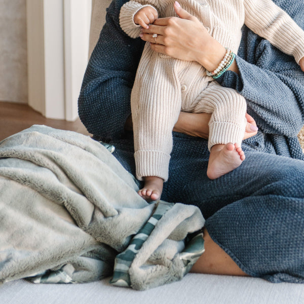 Plush toddler blanket featuring a satin back, blending a soft, warm texture on one side with a smooth, luxurious satin finish on the other.