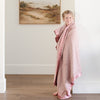 Cozy pink toddler blanket with a satin back, ideal for providing a comforting, silky-smooth embrace.