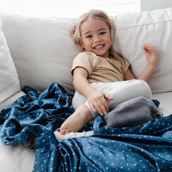 Soft and cozy toddler blanket with a star patterned satin back, perfect for snuggling and keeping warm.