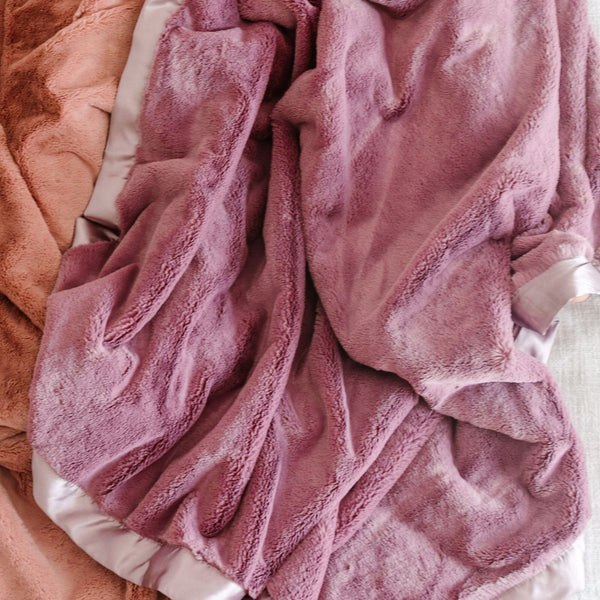 Luxurious pink and purple colored Saranoni toddler blanket with a deep, rich texture, designed to keep your child warm and snuggled in style.