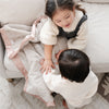 Warm and snuggly Saranoni toddler blanket, featuring a silky-soft texture that cradles your children in gentle luxury.