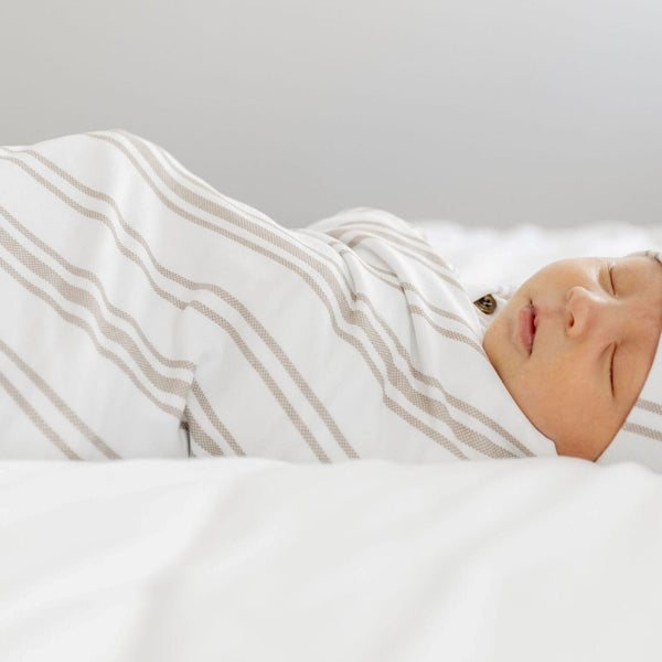 Adorable baby boy sleeping in super soft STRETCHY SWADDLES in neutral colors - Saranoni