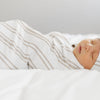 Adorable baby boy sleeping in super soft STRETCHY SWADDLES in neutral colors - Saranoni