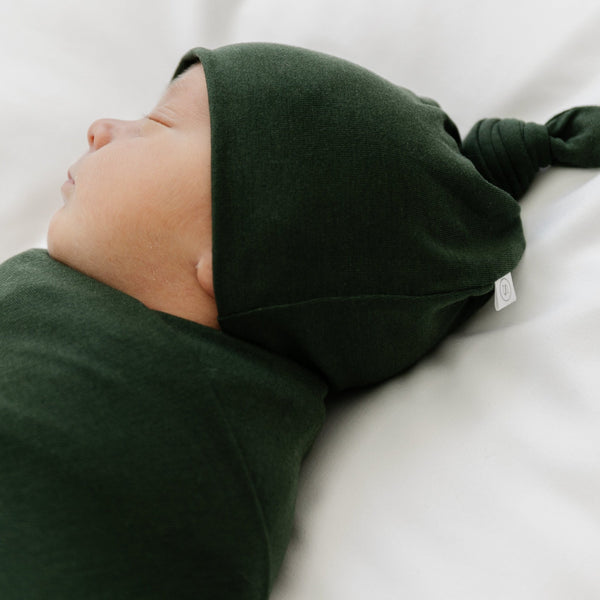 Side view of green baby hat and matching STRETCHY SWADDLES - Saranoni