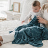 Newborn baby boy loving his new denim triangle blanket - STRETCHY SWADDLES - Saranoni