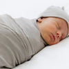 Baby peacefully sleeping in grey STRETCHY SWADDLE and matching hat- Saranoni