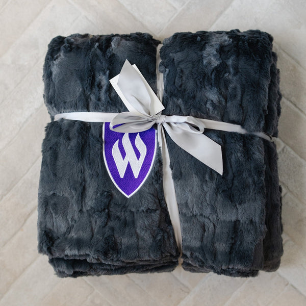 A Luxury Throw Charcoal Colored Patterned Faux Fur Saranoni Blanket. The soft blanket is a throw blanket and has a soft faux fur feeling. The blanket has a Weber State University Logo.