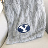 A Luxury Throw Gray Colored Patterned Faux Fur Saranoni Blanket. The soft blanket is a throw blanket and has a soft faux fur feeling. The blanket has a Brigham Young University Logo.