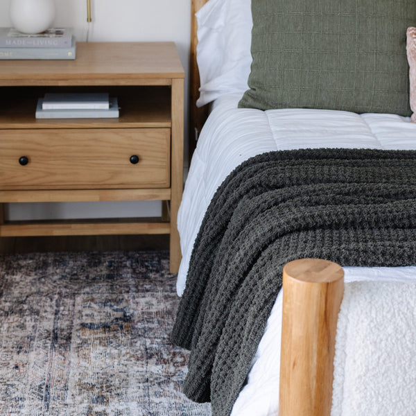 Deep green king-sized blanket featuring a modern waffle knit weave for a chic, textured look.