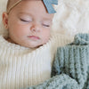 Detailed view of the intricate waffle knit pattern on an Elm mini blanket.