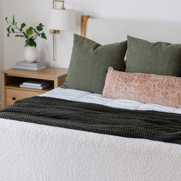 Cozy, green-colored, queen-size waffle knit blanket, perfect for layering on your bed.