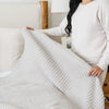 Warm and inviting pale oak, queen-size blanket with a lightweight waffle knit design.