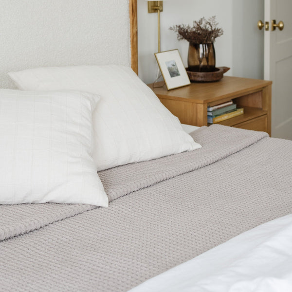 Stylish light grey queen blanket with a lightweight waffle knit texture for easy layering.