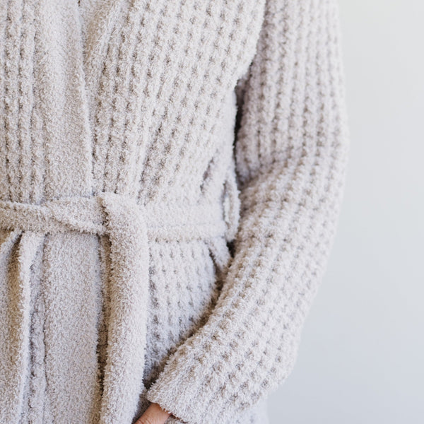 Up close of a person in a cozy, comfortable, waffle knit robe. 