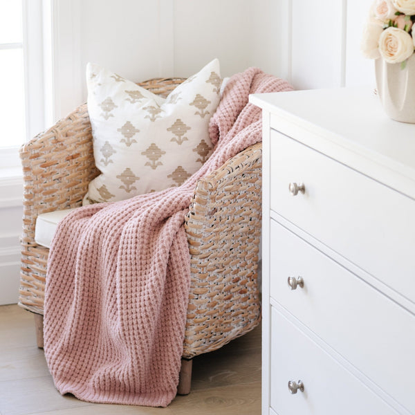 Rosette Waffle Knit Toddler blanket on chair in corner of little girl's bedroom